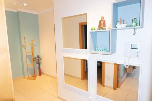 a room with a mirror and a white wall at Apartments Baleal: Balconies and Pool in Ferrel
