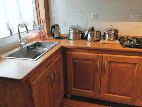 a kitchen counter with a sink and a stove at Akhard Haus in Buea