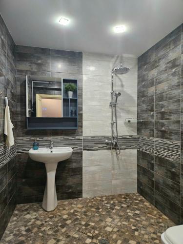 a bathroom with a sink and a shower at Apartment 22 in Veliko Tŭrnovo