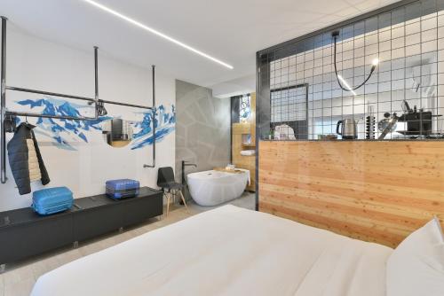 a bathroom with a bed and a tub and a sink at Le Lion Apartments - Bike & Ski in Aosta