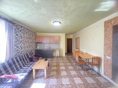 a living room with a couch and a table at Rob B&B in Garni