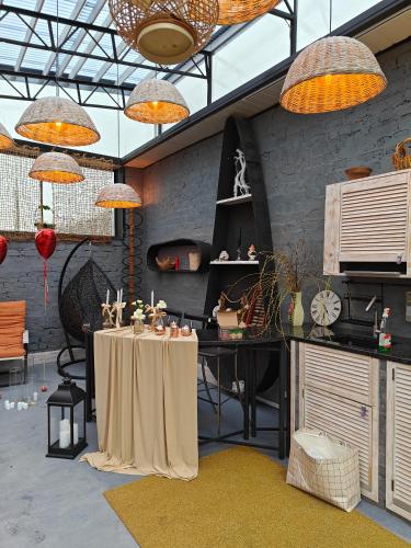 a room with a table in a room with lamps at loft apartments OLD MILL in Sarny