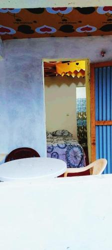 a dining room with a table and chairs in a room at Petit Hollande guest rooms in Abene