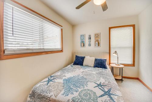 a bedroom with a bed and a window at Private Boat Dock Fall Escape in Outer Banks! in Kill Devil Hills