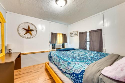 a bedroom with a bed and a clock on the wall at Cabana Luna Cabin with Deck, Swing and Fire Pit! in Rio Frio