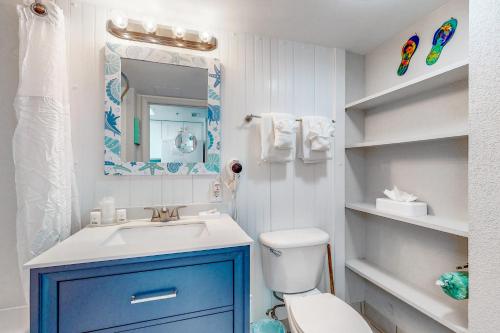 a bathroom with a blue cabinet next to a toilet at Bay Watch 0536 in Myrtle Beach