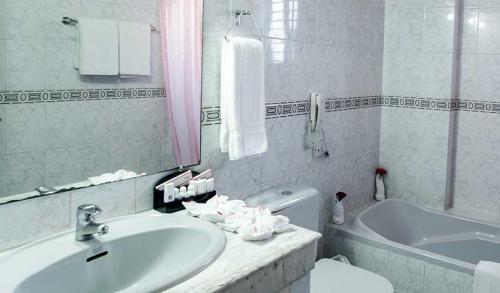 a white bathroom with a sink and a tub at HOTEL LAKE CASTLE - Parkview in Dhaka