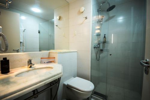 a bathroom with a sink and a shower and a toilet at Xtay Guarulhos Aeroporto in Guarulhos