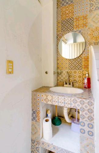 a bathroom with a sink and a mirror at 4.Guadalajara, corazón del centro historico. in Guadalajara