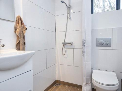 a white bathroom with a shower and a toilet at Holiday home Hovborg XIV in Hovborg
