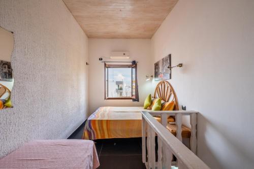 a small room with a bed and a window at Villa Gaudì - Mallorca in Sant'Isidoro