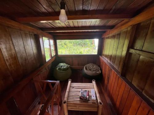 Cabaña pequeña con banco y ventana en Casa de campo en el bosque de Mindo, junto al río, en Mindo