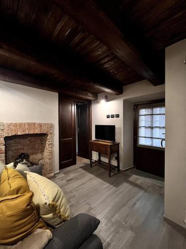 a living room with a couch and a piano at La Grangia in Giaveno