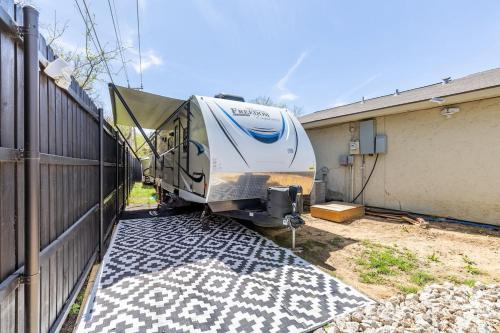 a trailer is parked next to a house at The Great Escape in Fort Worth