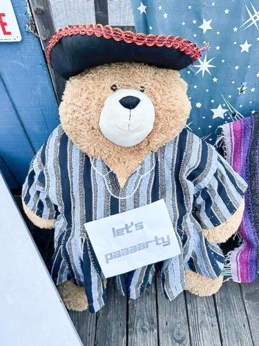 a teddy bear wearing a hat with a sign on it at ITH San Francisco Pacific Tradewinds Backpacker Hostel in San Francisco
