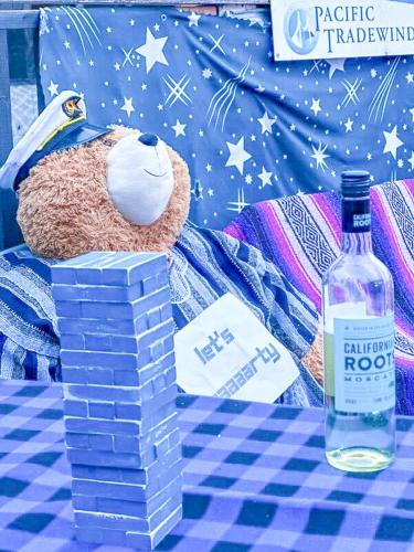 a teddy bear sitting next to a bottle of vodka at ITH San Francisco Pacific Tradewinds Backpacker Hostel in San Francisco