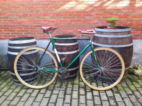 a bike is parked next to two barrels at Hotel Rural Cuartamenteru in Llanes