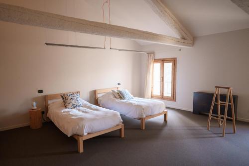a room with two beds and a window at FARM HOUSE in Roncade