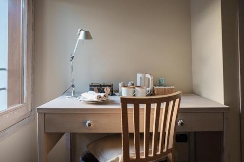 a desk with a chair and a lamp on it at FARM HOUSE in Roncade