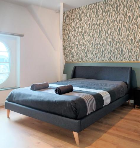 a bed with two towels on it in a bedroom at "Au pied du Beffroi" - Superbe emplacement in Arras