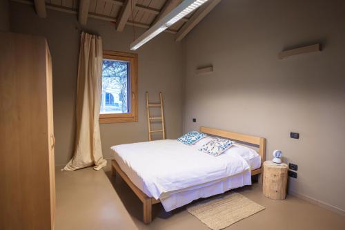 a bedroom with a bed and a window at FARM HOUSE in Roncade