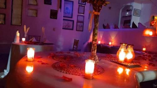 a table with candles on it in a room at Parejas in La Orilla