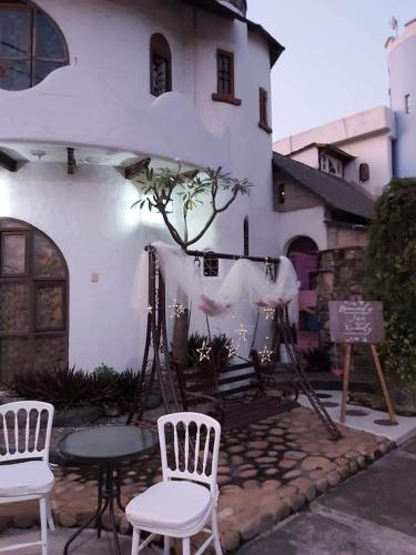 a group of chairs and tables in front of a building at Parejas in La Orilla