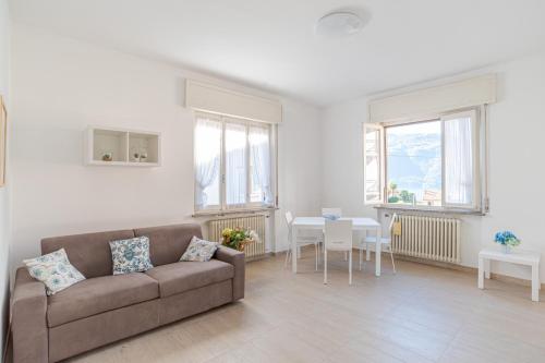 a living room with a couch and a table at GuestHost - La Perla in Lierna