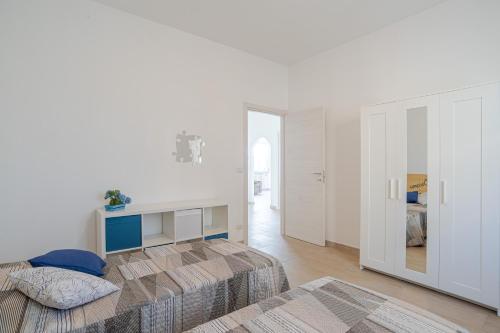 a bedroom with a bed and a desk in it at GuestHost - La Perla in Lierna