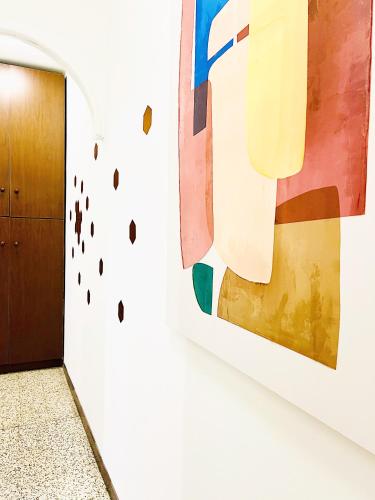 a hallway with a painting on a wall next to a door at The Luxe by Maiden Art in Arona