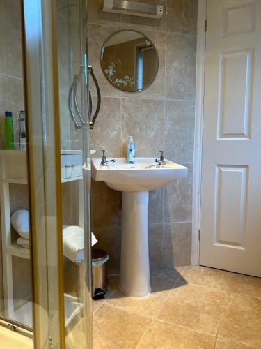 a bathroom with a sink and a mirror at THE FIRS B&B &TEA ROOM in Summer Bridge
