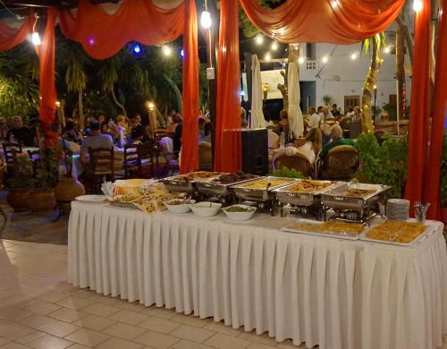 a buffet of food on a table at a party at Vasilaras Hotel in Skala