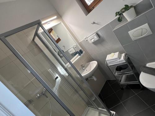 a bathroom with a shower and a sink and a toilet at Margaréta Garden & SPA in Eger