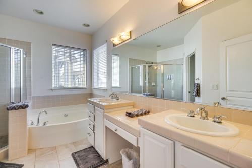 a bathroom with a sink and a bath tub and a sink at 5 Mi to Downtown Reno Home with Lake Access! in Sparks