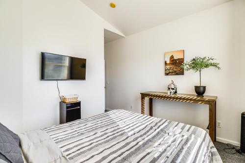 a bedroom with a bed and a tv on the wall at 5 Mi to Downtown Reno Home with Lake Access! in Sparks