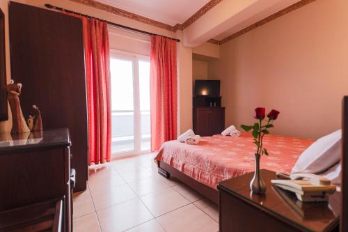 a hotel room with a bed and a window at Kymata in Paralia Katerinis