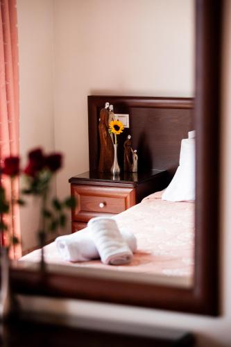 a bedroom with a bed and a table with a mirror at Kymata in Paralia Katerinis