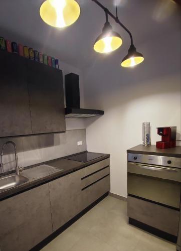 a kitchen with a sink and two lights on the ceiling at Villa Emily appartamento in Ca Tiepolo