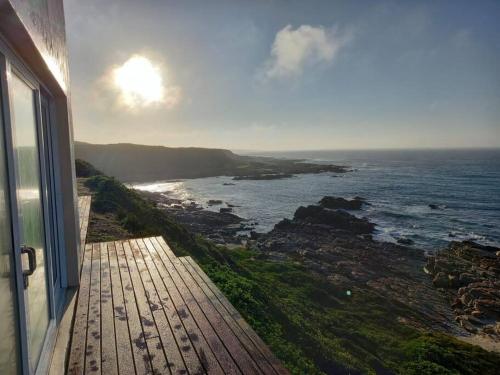 a view of the ocean from a balcony of a house at Rusenvrede Self Catering in Cape St Francis
