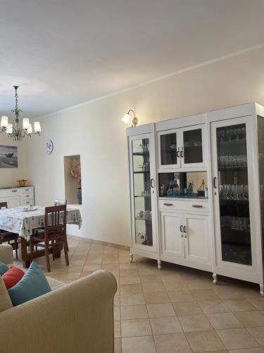 a living room with a table and a white cabinet at Sweet Dream House in Carloforte