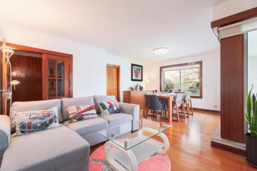 a living room with a couch and a table at Apartment Qian Rio Douro 2BR Free Parking in Porto