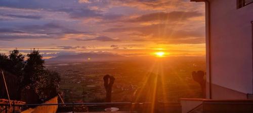 a view of the sunset from a balcony of a building at "FUERTE " Affittacamere in Montevettolini