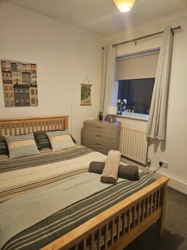 a bedroom with two beds and a window at cleethorpes seaside garden apartment in Cleethorpes