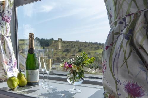 a bottle of wine and glasses on a window sill at Dartmoor Inn Merrivale in Yelverton