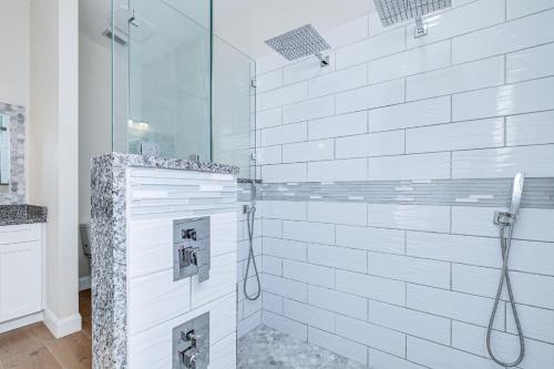 a bathroom with a shower with white subway tiles at Valrico Home with Yard about 14 Mi to Downtown Tampa in Valrico