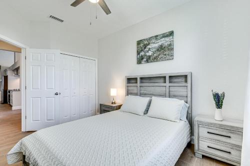 a white bedroom with a bed and a ceiling fan at Valrico Home with Yard about 14 Mi to Downtown Tampa in Valrico