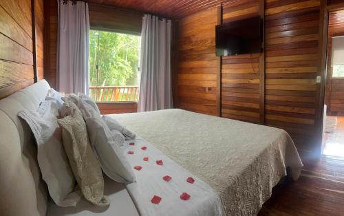 a bedroom with a bed with red hearts on it at Chalé Girassol in Venda Nova do Imigrante