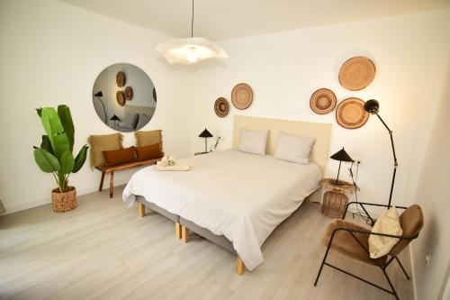 a bedroom with a large white bed and a chair at Casa Lucia in Villaverde