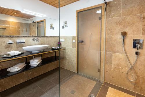 a bathroom with a shower and a sink at Landhaus Am Arzbach in Bad Tölz