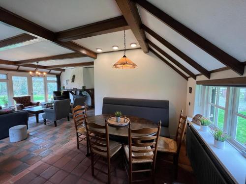 a dining room with a table and chairs at Unieke Twentse boerderij - 4 bedrooms & huge private garden in Den Ham